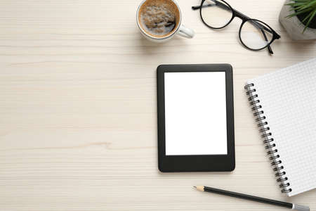 Flat lay composition with modern e-book reader on white wooden table, space for textの写真素材