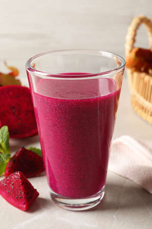 Delicious pitahaya smoothie and fresh fruits on light gray tableの写真素材