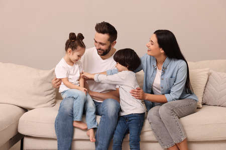 Happy family resting on sofa in living room