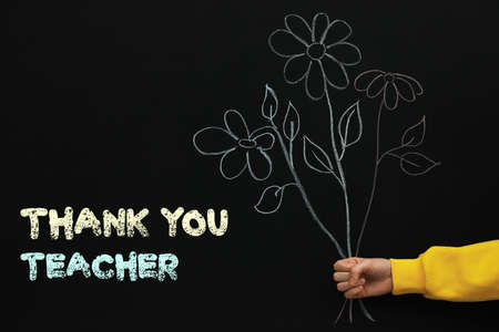 Woman near blackboard with drawn bouquet and phrase Thank You Teacher, closeupの写真素材