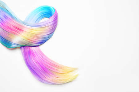 Strand of beautiful multicolored hair on white background, top viewの写真素材