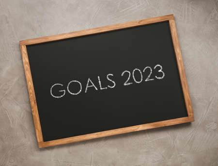 Blackboard with phrase GOALS 2023 on light gray stone background, top viewの写真素材