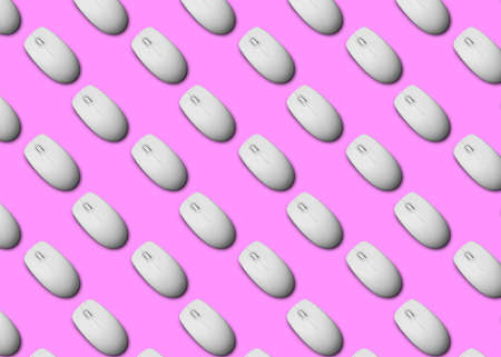 Many white computer mice on pink background, flat lay. Seamless pattern designの写真素材