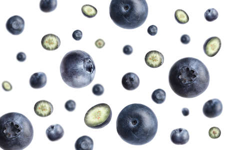 Tasty ripe blueberries flying on white backgroundの写真素材