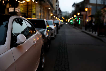 City street with parked cars in the eveningの写真素材