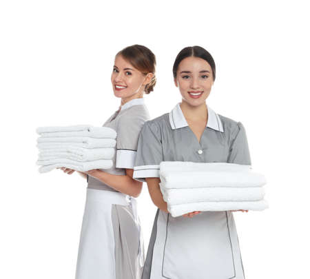 Portrait of chambermaids with towels on white backgroundの写真素材