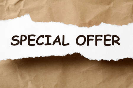 Torn sheet of paper with phrase Special Offer on crumpled beige background, top viewの写真素材