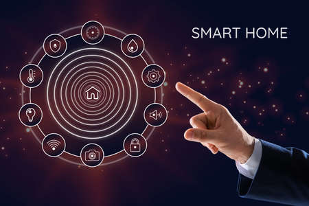 Man using digital screen with Smart Home interface on dark background, closeupの写真素材