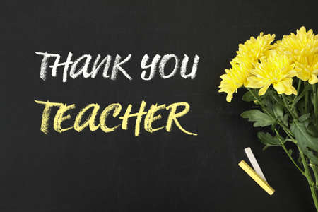 Phrase Thank You Teacher, beautiful flowers and chalk on blackboard, flat layの写真素材
