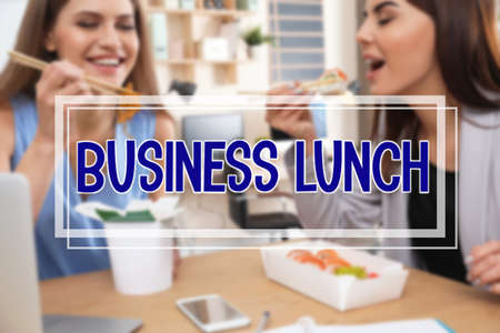 Office employees eating at the workplace. business lunchの写真素材