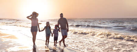 Happy family on sandy beach near sea, space for text. banner designの写真素材