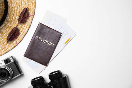 Flat lay composition with passport, tickets and holiday items on white background. Space for textの写真素材