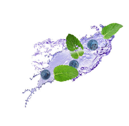 Fresh ripe blueberries, mint and splashing juice on white backgroundの写真素材