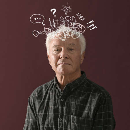 Elderly man with dementia on brown background. Illustration of messy thoughts during cognitive impairmentの写真素材