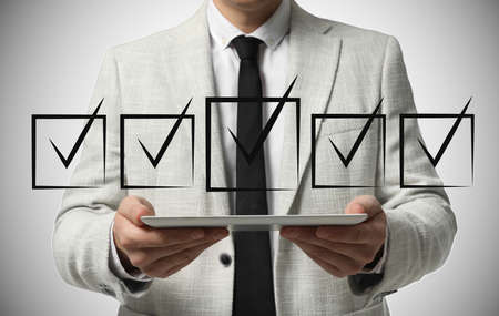 Illustration of check boxes with marks and man using tablet on light background, closeup
