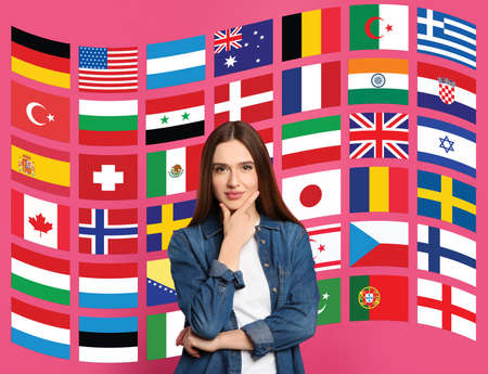 Portrait of interpreter and flags of different countries on pink background