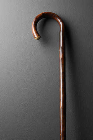 Elegant wooden walking cane on gray backgroundの写真素材