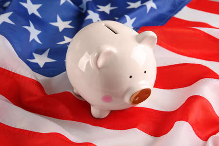 White piggy bank on American flag, closeupの写真素材