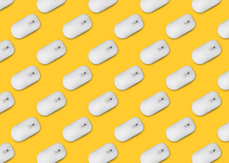 Many white computer mice on yellow background, flat lay. Seamless pattern design
