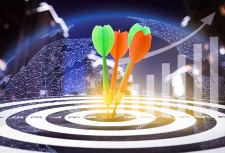 darts hitting target on board, illustration of graph, Earth planet and blurred of cityscape view. multiple exposureの写真素材