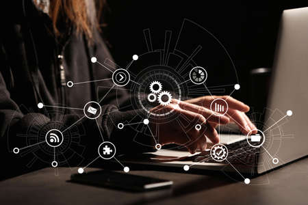 Cyber security concept. Illustration of different virtual icons and woman working with laptop at table, closeupの写真素材