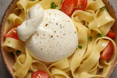 Bowl of delicious pasta with burrata and tomatoes, closeupの写真素材