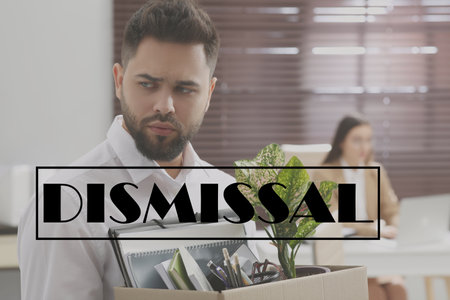 Upset dismissed man carrying box with personal stuff in officeの写真素材