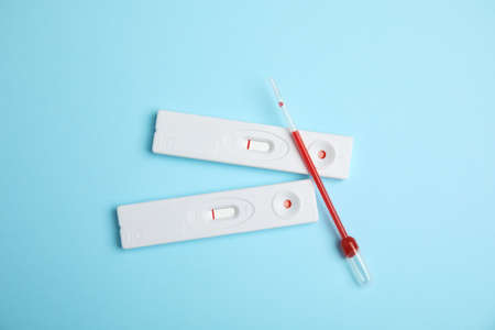 Disposable express hepatitis test kit on light blue background, flat layの写真素材