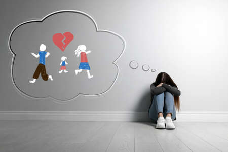 Girl upset because of parents divorced at home. illustration of broken heart and familyの写真素材