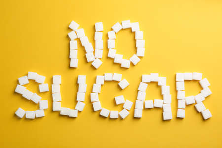 Phrase No Sugar made of refined cubes on yellow background, flat layの写真素材