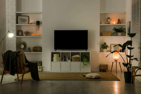 Stylish wide TV set on stand in roomの写真素材