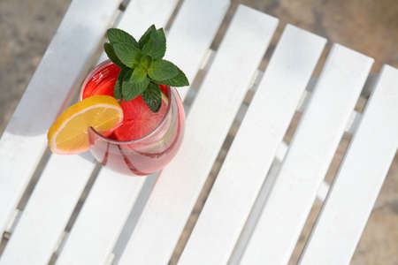 Glass of delicious cocktail on white wooden table, space for text. Refreshing drinksの写真素材