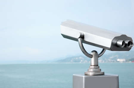 Metal tower viewer installed near sea, space for text. Mounted binocularsの写真素材