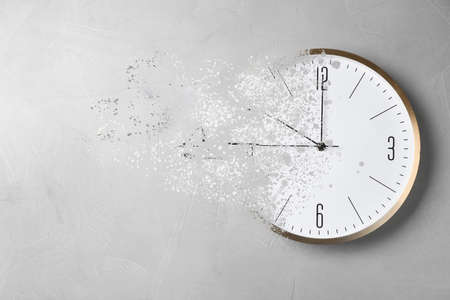 Time is running out. Clock vanishing on light backgroundの写真素材