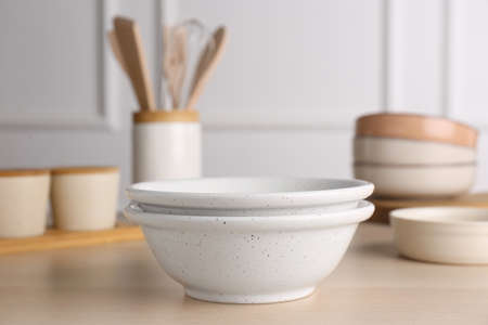 Two ceramic bowls on wooden table indoorsの写真素材