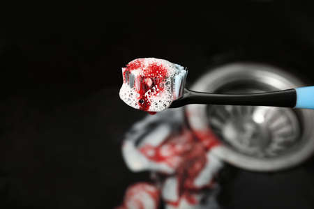 Toothbrush with paste and blood over sink, closeup. gum inflammationの写真素材