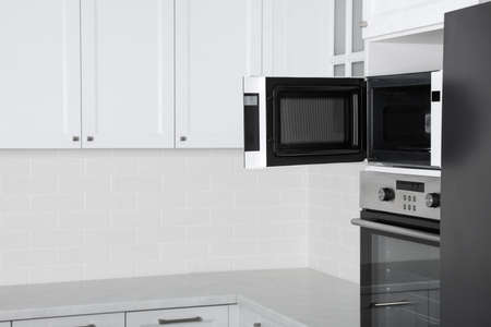 Modern oven and microwave in white clean kitchenの写真素材