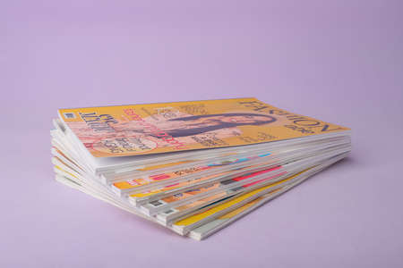 Group of stacked magazines on blue backgroundの写真素材