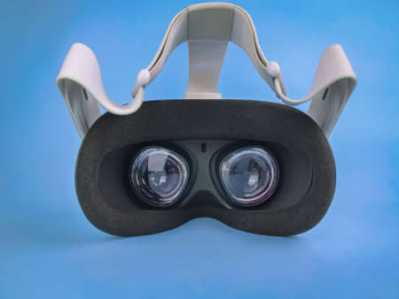 Modern virtual reality headset on light blue backgroundの写真素材