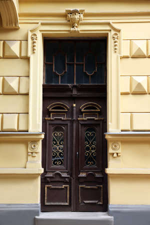 Entrance of house with beautiful wooden door, elegant moldings and transom windowの写真素材