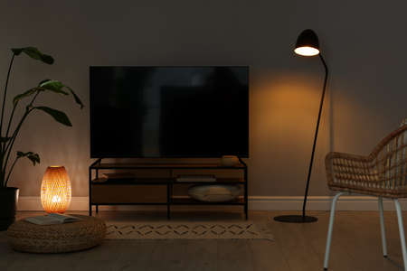 Stylish wide TV set on stand in roomの写真素材