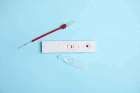 Disposable express hepatitis test kit on light blue background, flat layの写真素材