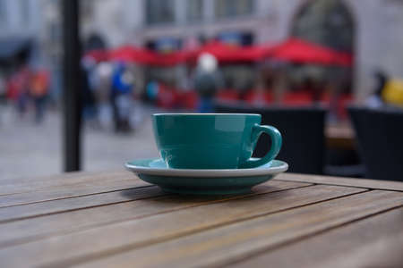 Cup of aromatic hot coffee on wooden table in outdoor cafeの写真素材