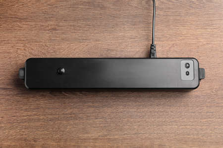 Sealer for vacuum packing on wooden table, top viewの写真素材