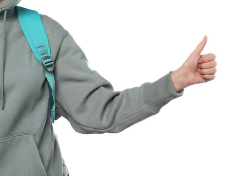 Woman with backpack hitchhiking on white background, closeup