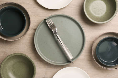 Different, bowls and cutlery on wooden table, flat plates layの写真素材