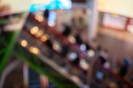 Blurred view of modern shopping mall interior with escalatorの写真素材