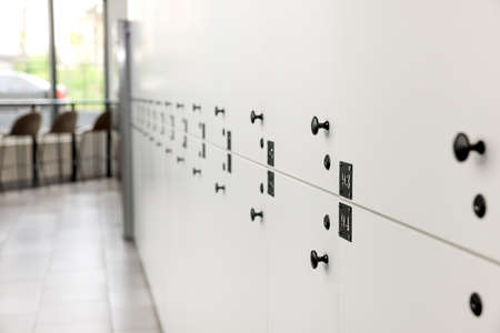 Rows of white lockers in modern hostel