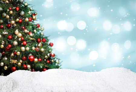 Beautifully decorated Christmas tree and snow on light blue background, space for text. bokeh effectの写真素材