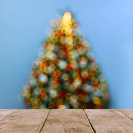 Empty wooden table and blurred view of beautiful Christmas tree. space for designの写真素材